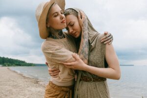 My Personal Gay Stories Tender moment between a couple hugging on a serene beach. Capturing emotion and connection.